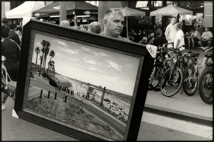 102_Man carries painting of HB